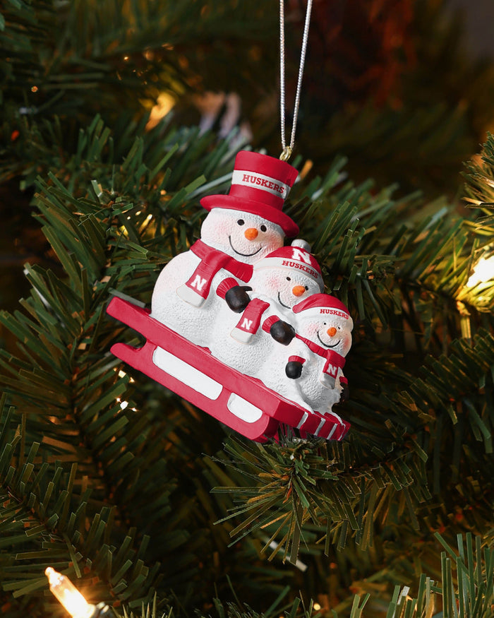 Nebraska Cornhuskers Sledding Snowmen Ornament FOCO - FOCO.com