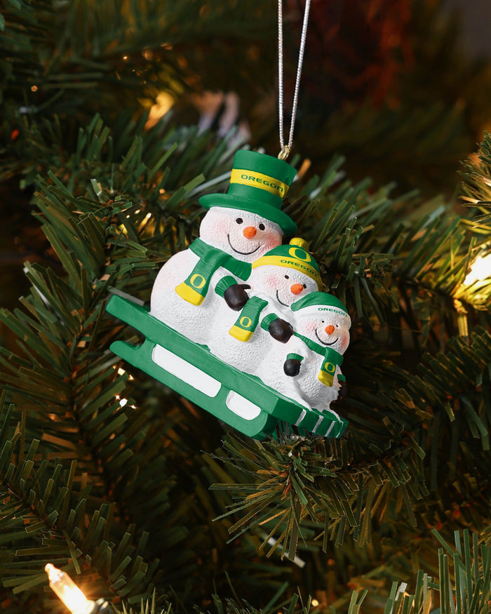 Oregon Ducks Sledding Snowmen Ornament FOCO - FOCO.com